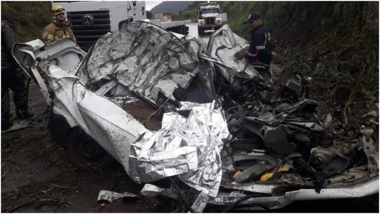 Carreta que carregava escavadeira tomba e duas pessoas morrem após carro ser esmagado